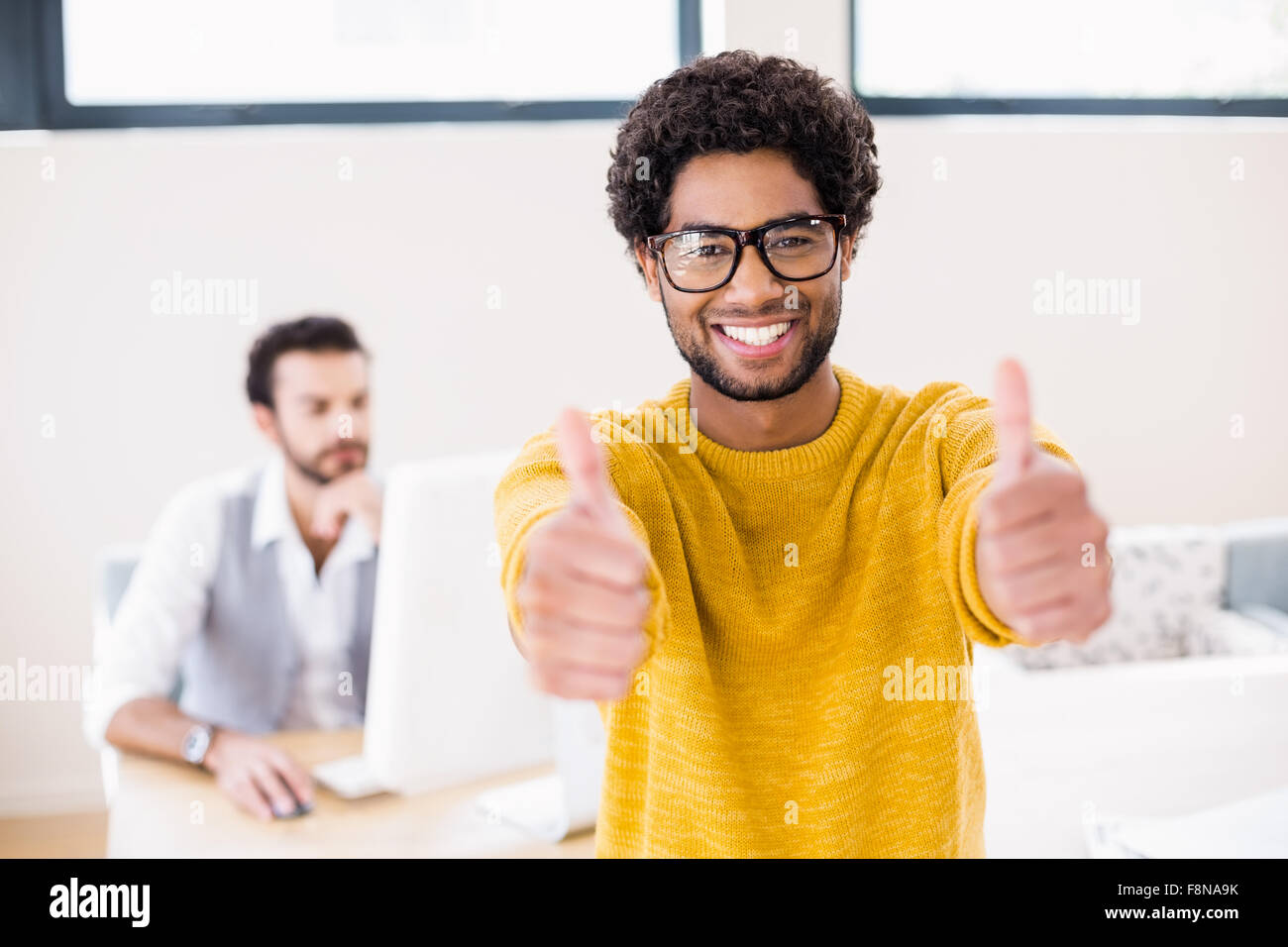 Smiling man showing thumbs up Stock Photo
