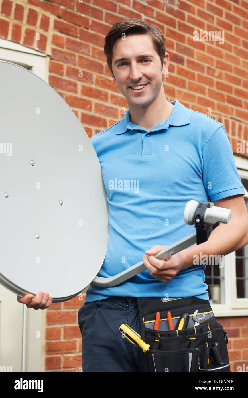 Man Fitting TV Satellite Dish To House Wall Stock Photo Alamy