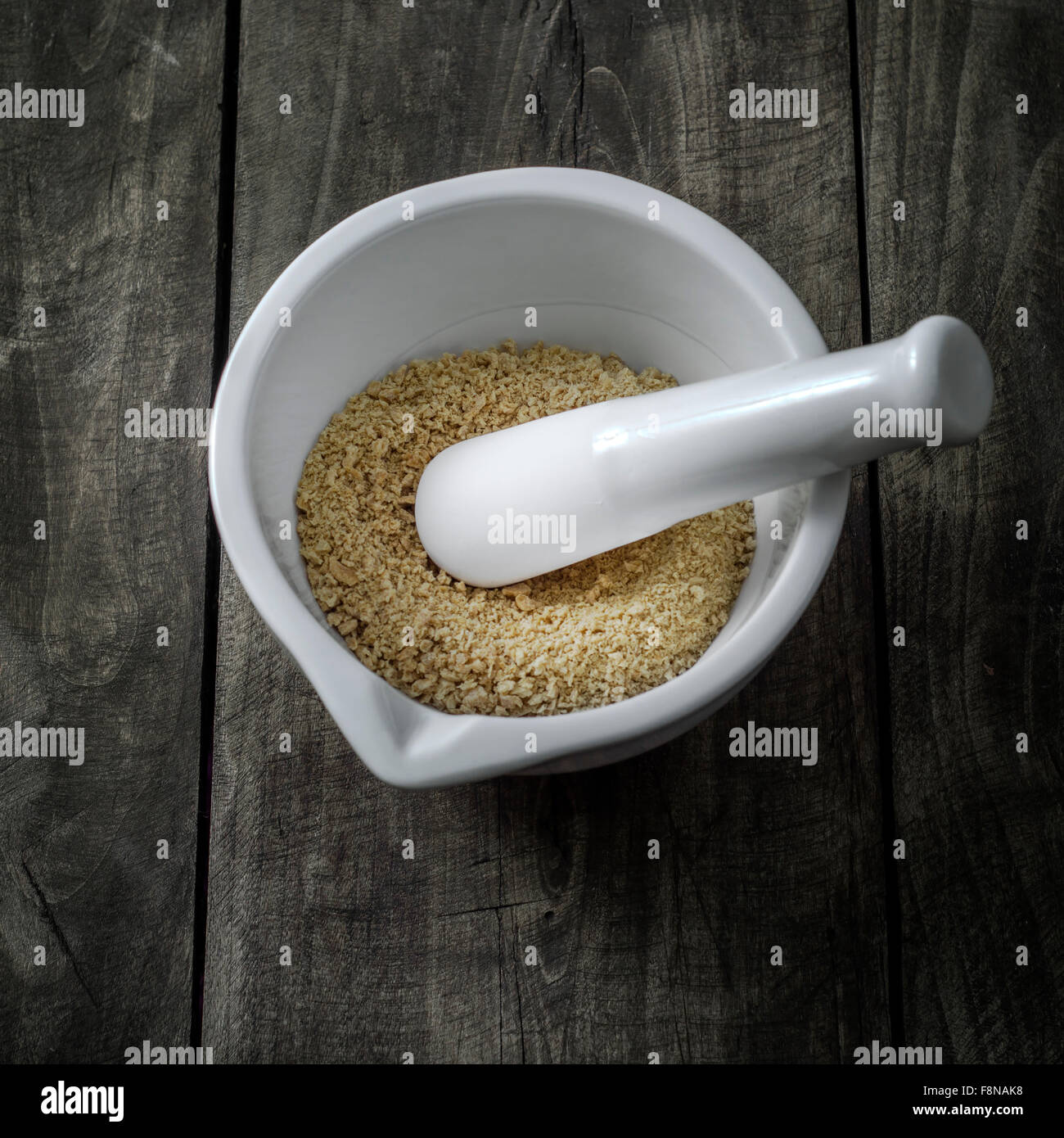 Soya bean in a mortar on wooden table, from above Stock Photo