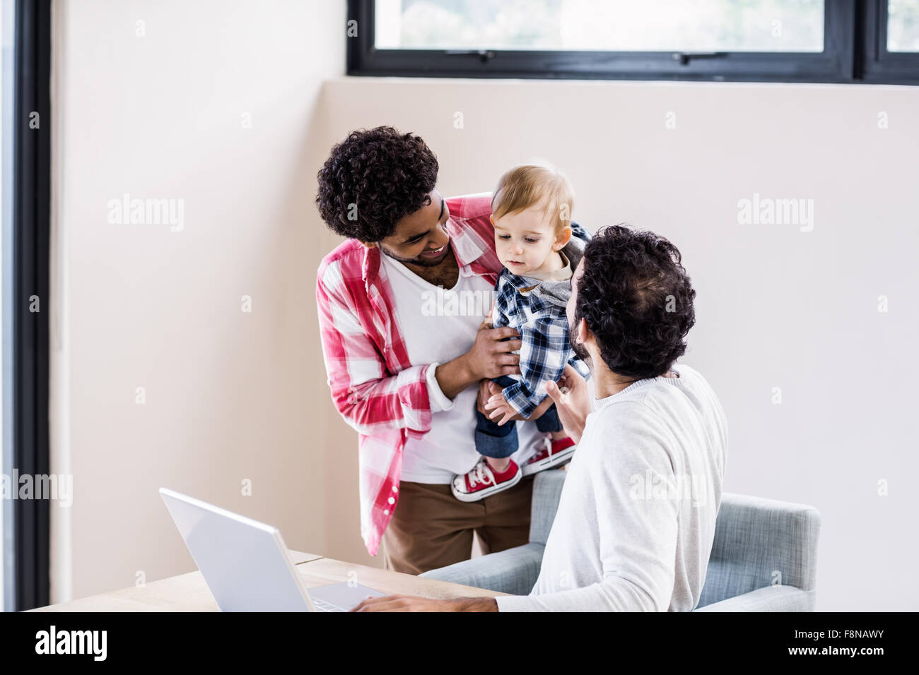 Happy gay couple with child Stock Photo