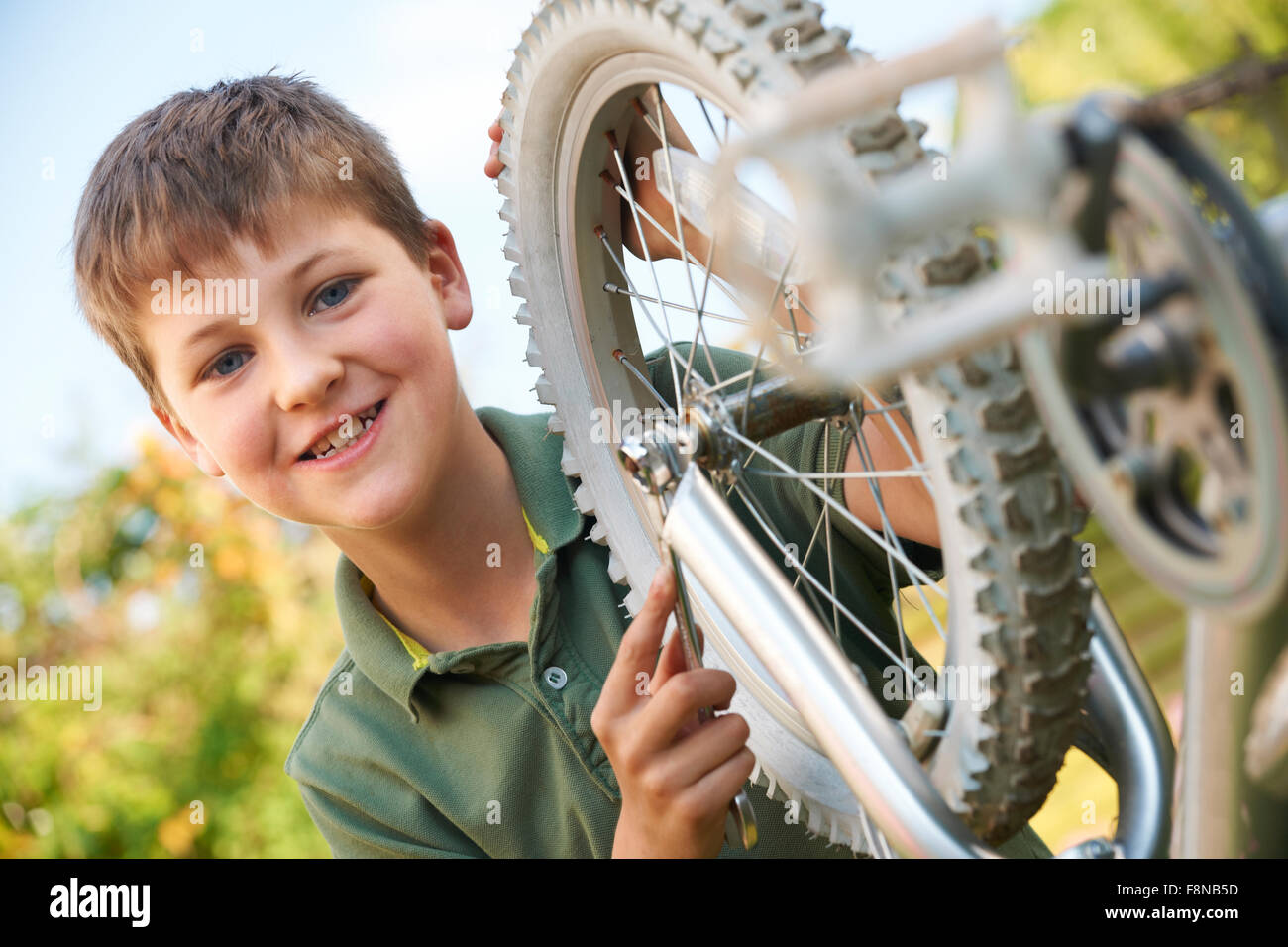 Boy Fixing Wheel Of Bike Stock Photo Alamy