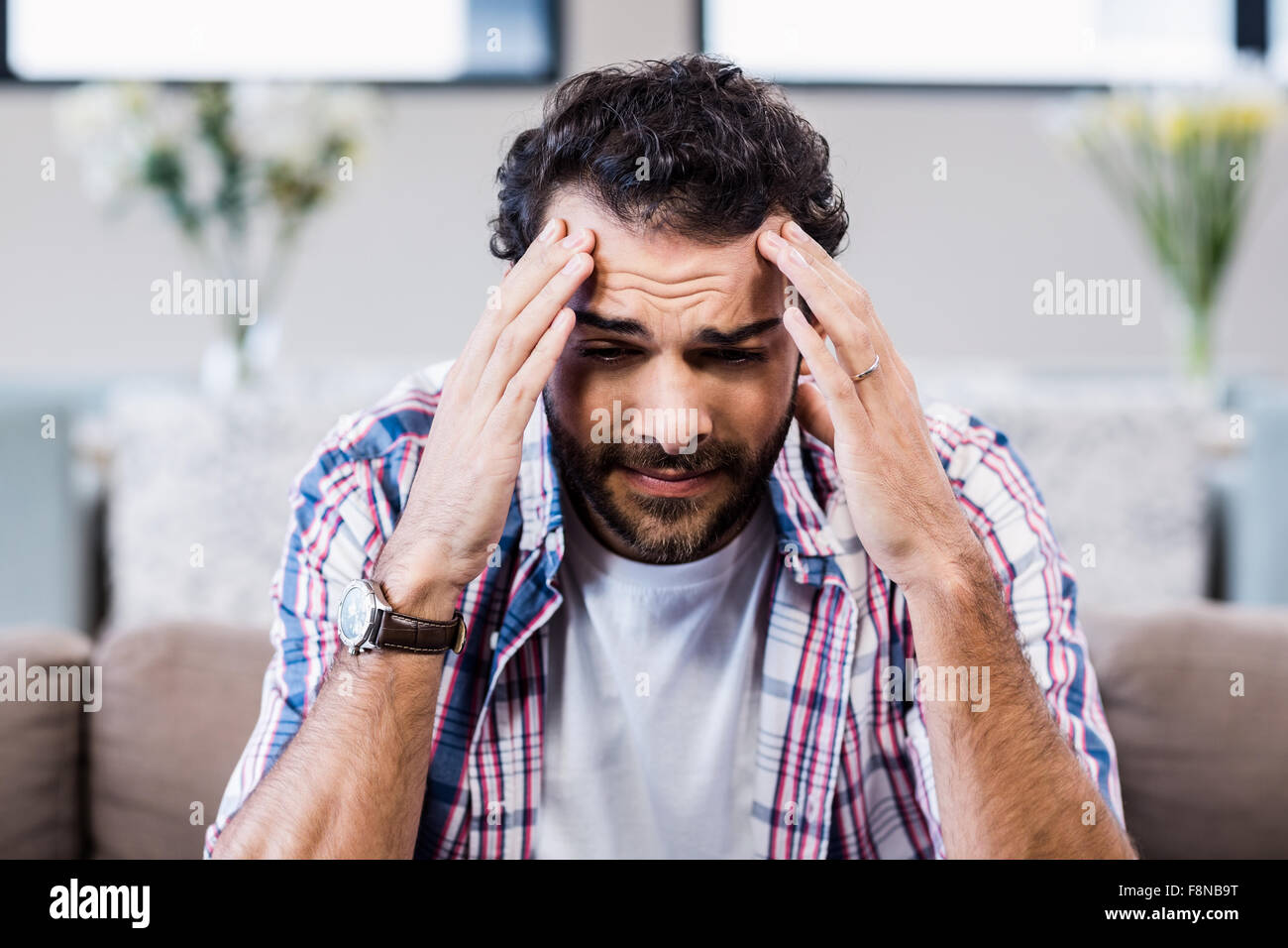 Worried man with hands on his face Stock Photo