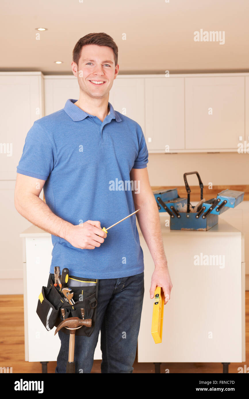 Workman Installing Beautiful Fitted Kitchen Stock Photo