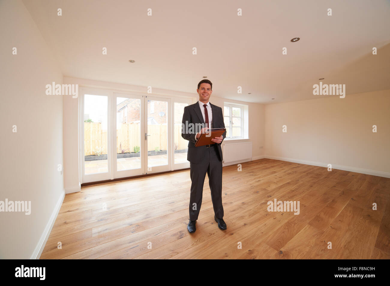 Estate Agent Looking At Vacant Property Stock Photo
