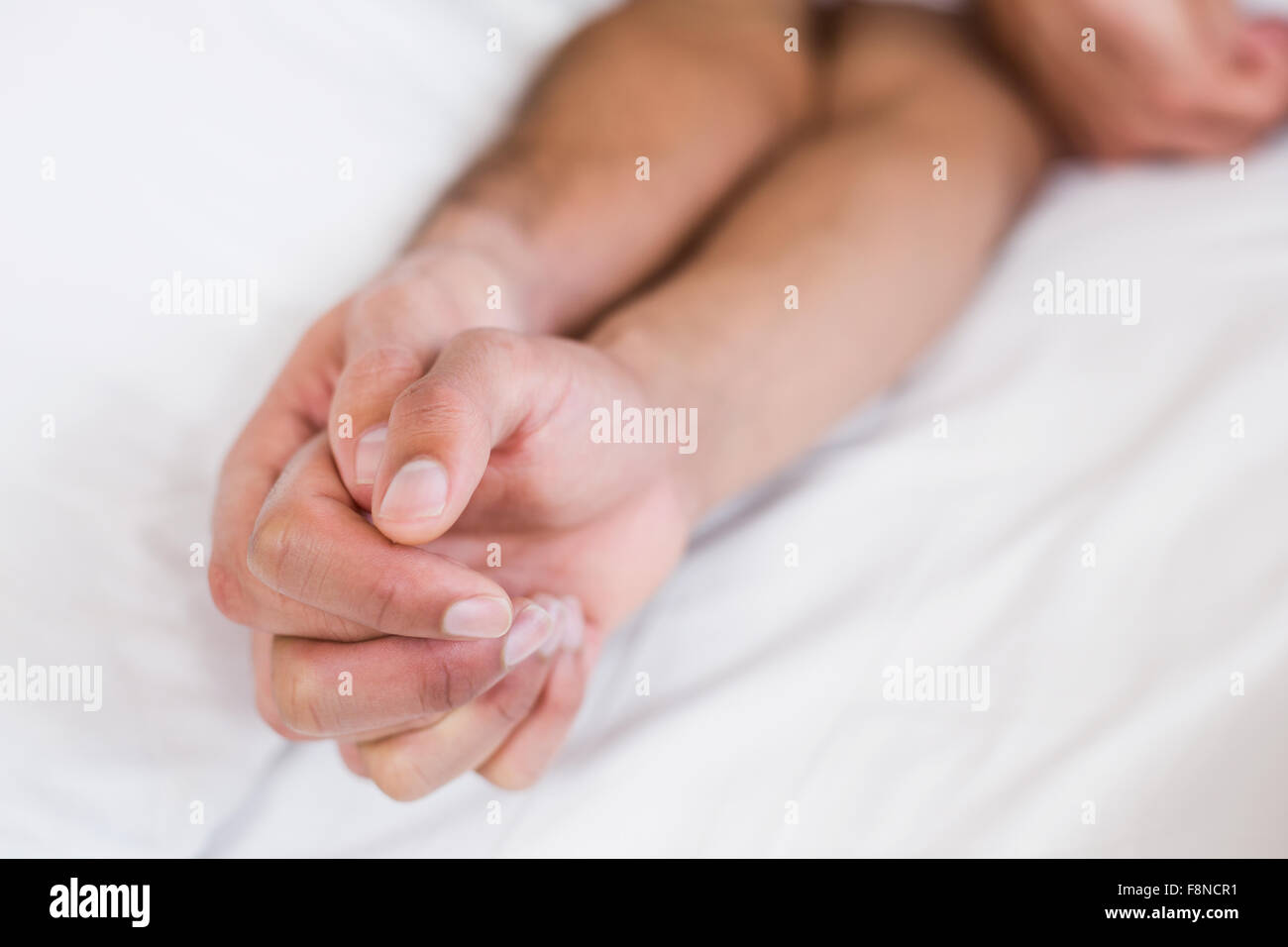 Close up of homosexual couple holding hands Stock Photo