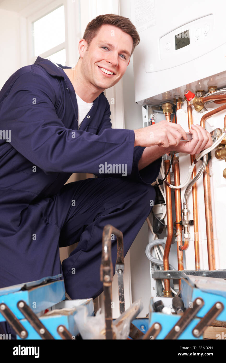 Engineer Servicing Central Heating Boiler Stock Photo