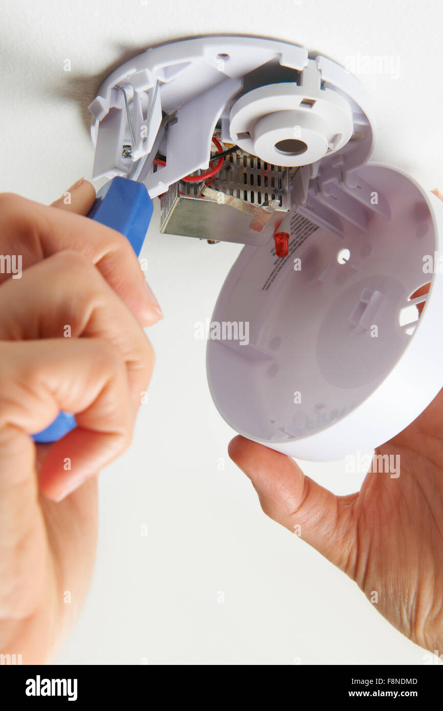 Installing Smoke Detector At Home Stock Photo