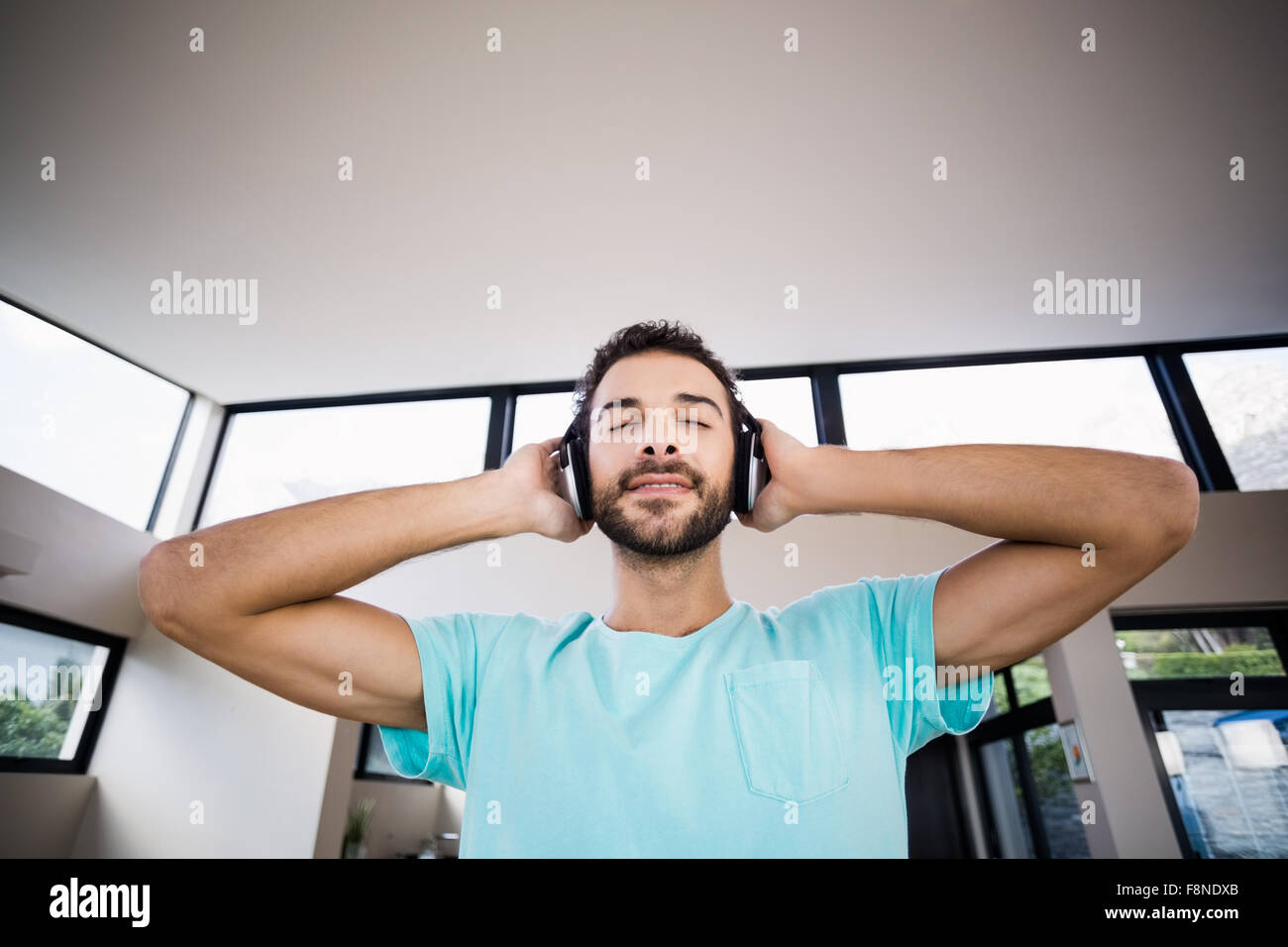 Relaxed man with hands on headphones Stock Photo