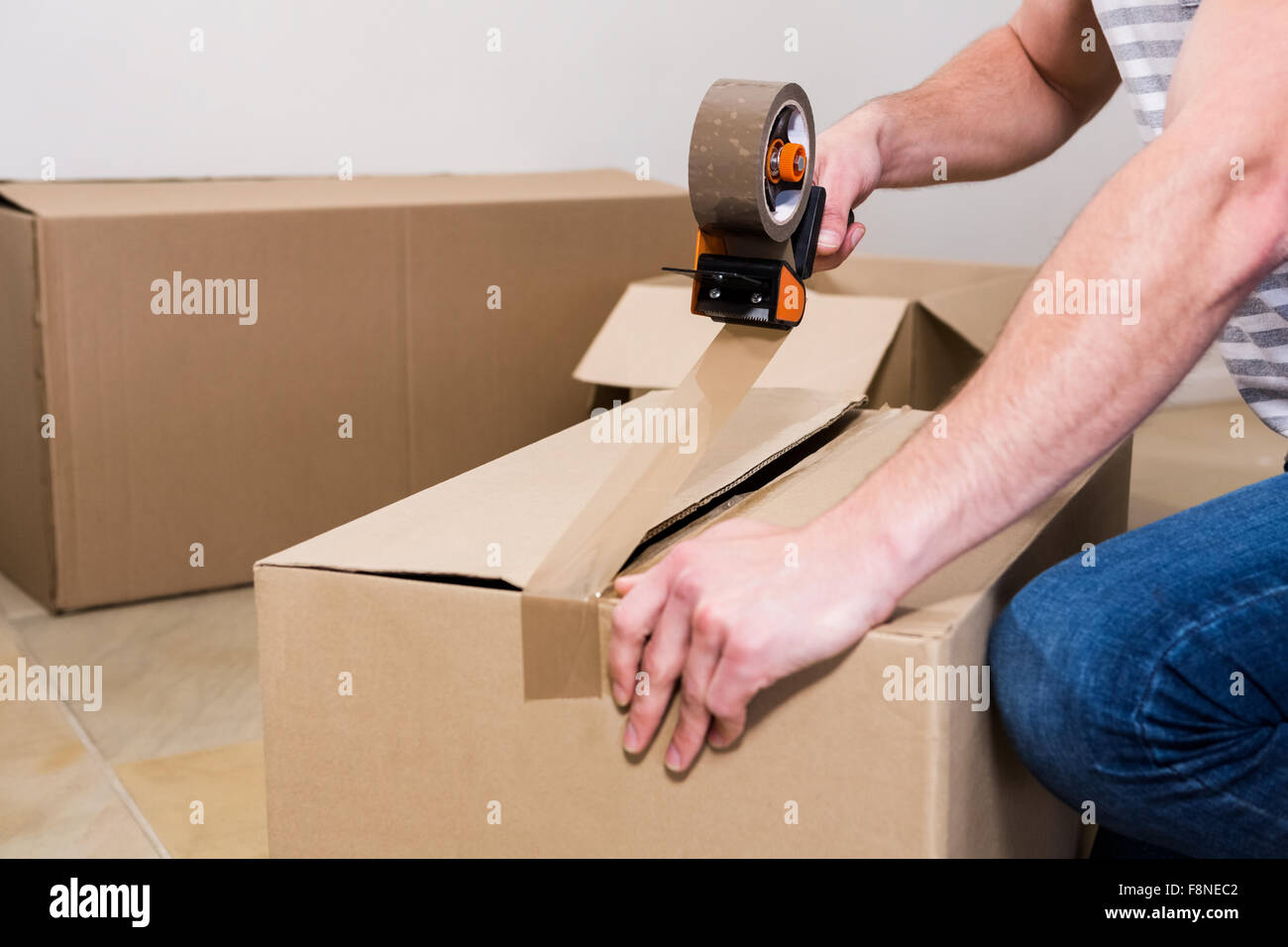 Man taping up moving box Stock Photo