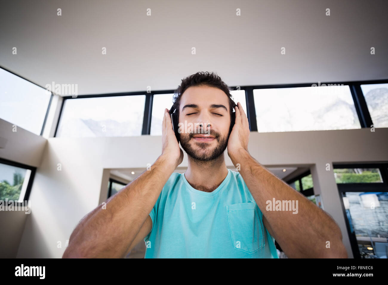 Relaxed man with hands on headphones Stock Photo