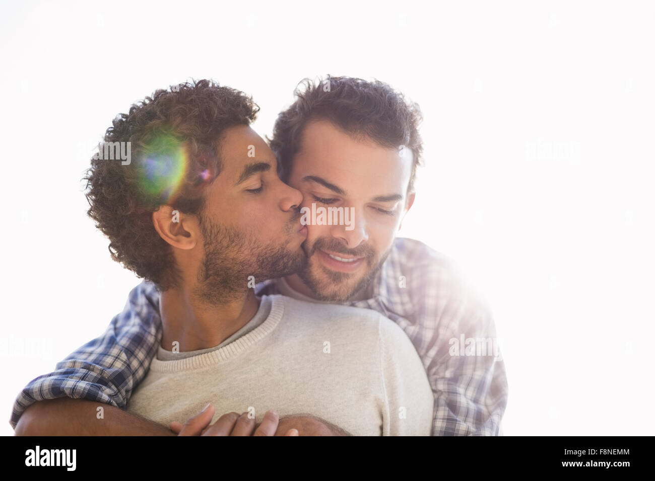 Happy gay couple cuddling Stock Photo