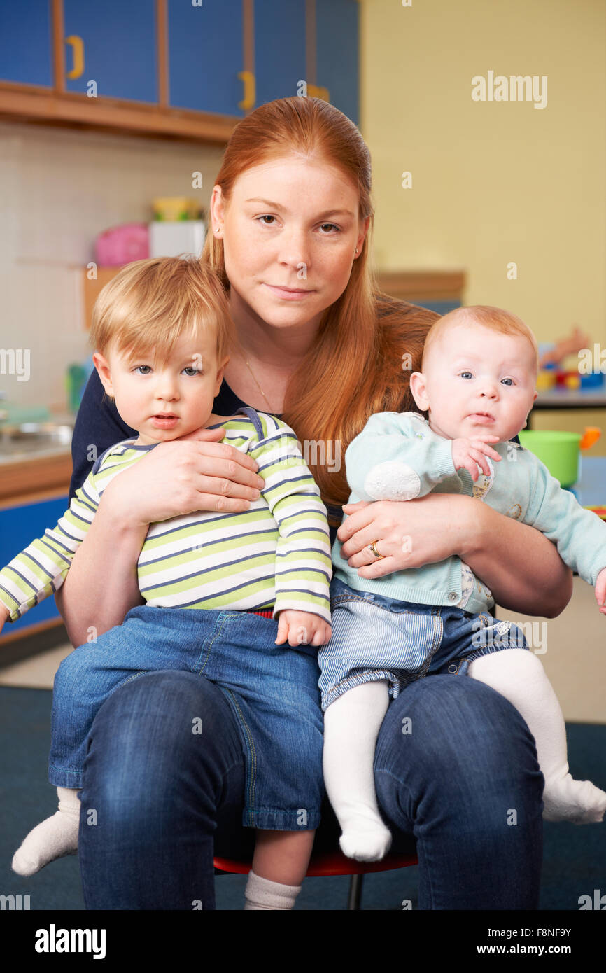 Stressed Mother With Two Young Children At Baby Group Stock Photo