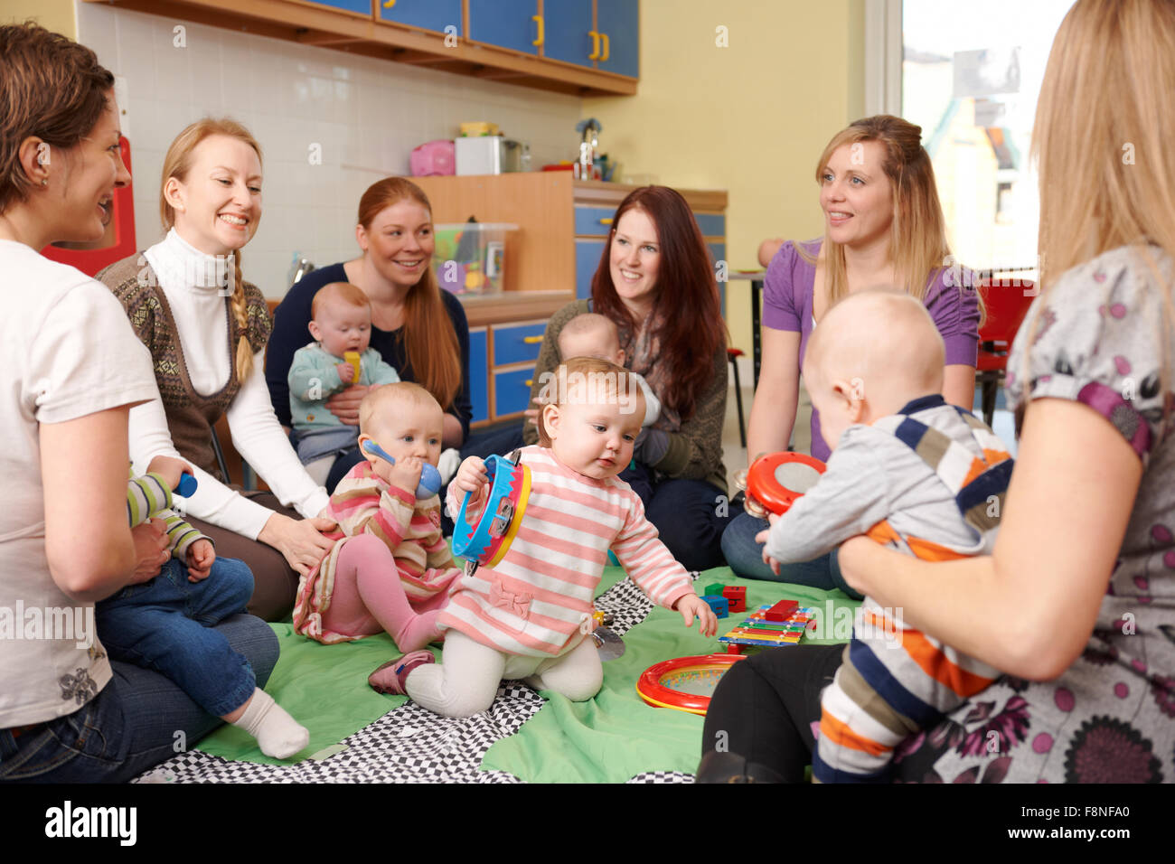 Group Of Mothers With Babies At Playgroup Stock Photo
