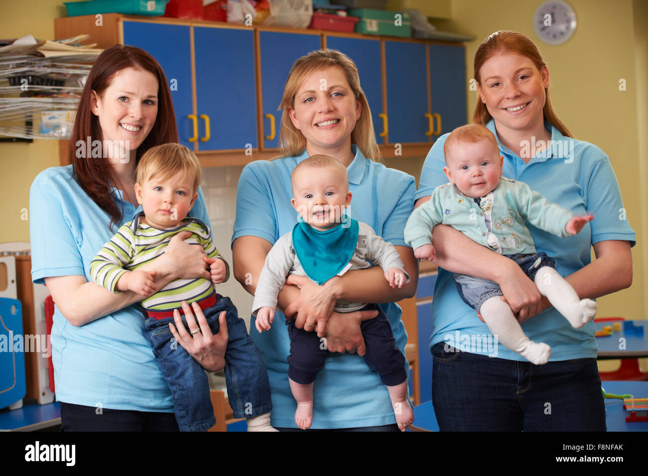 Group Of Workers With Babies In Nursery Stock Photo