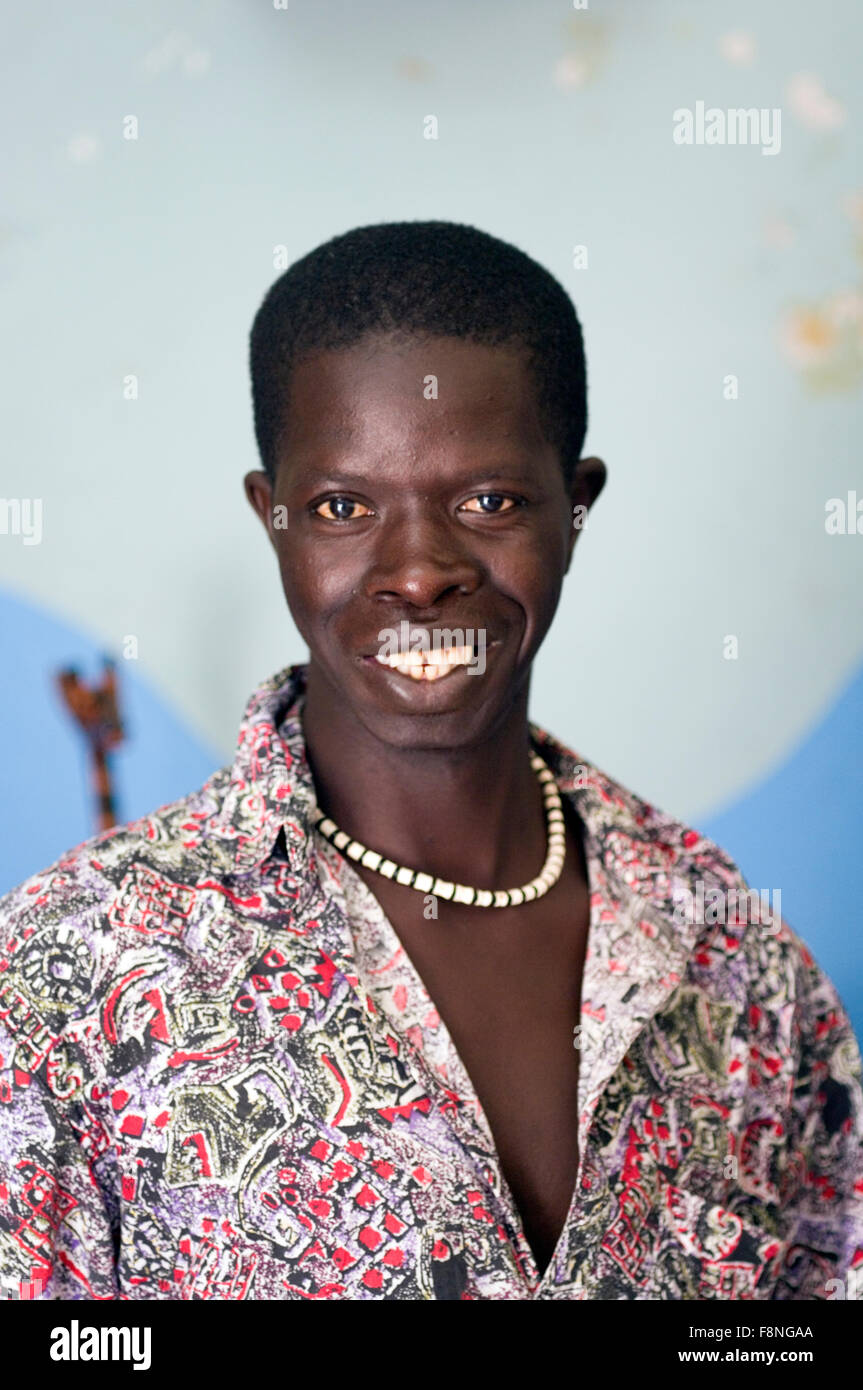 Gambian man with a pearl or shell necklace, shirt open smiling on the  island republic of Cape Verde Stock Photo - Alamy