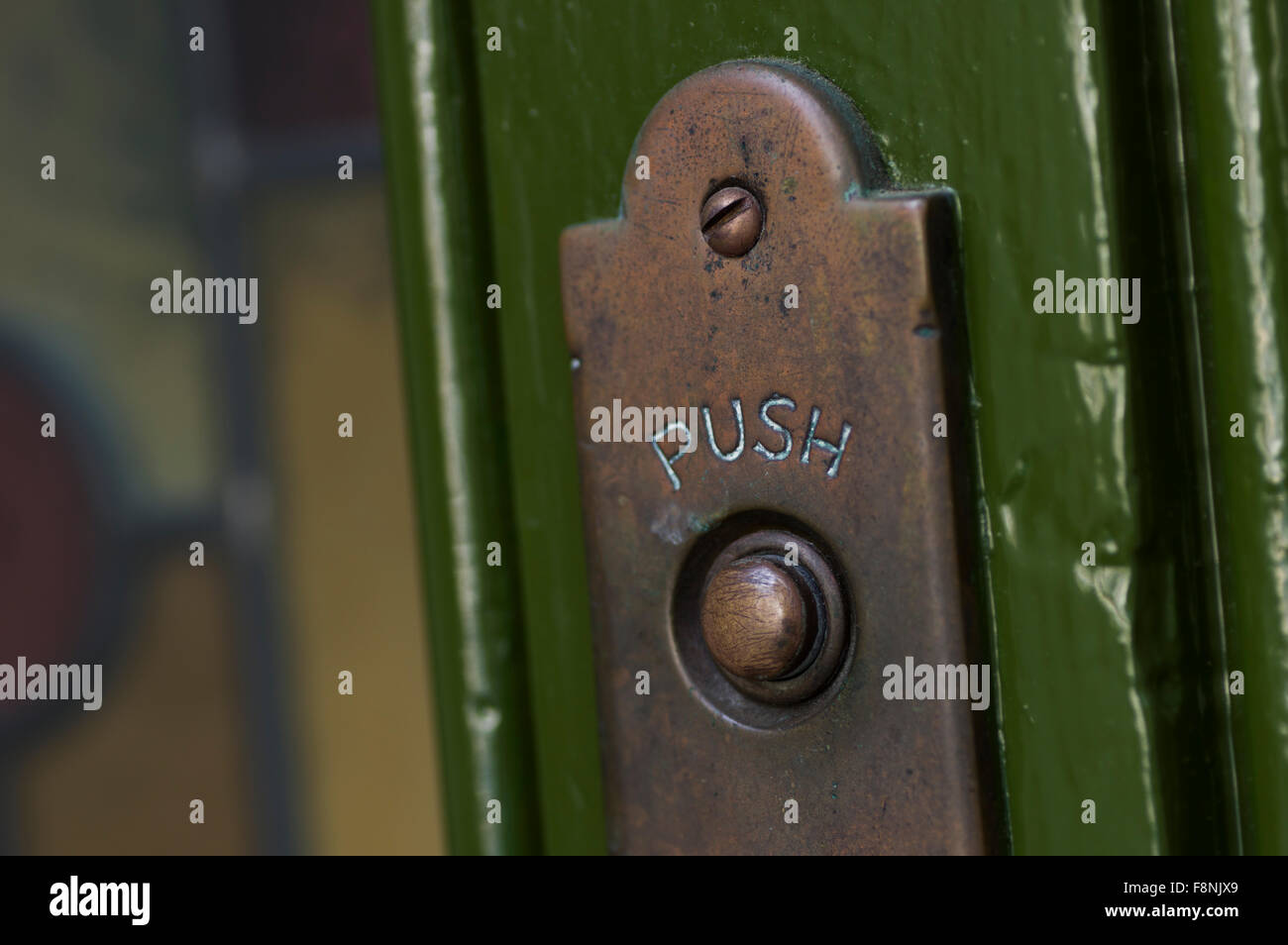 Old, tarnished brass door bell on a green wall Stock Photo Alamy