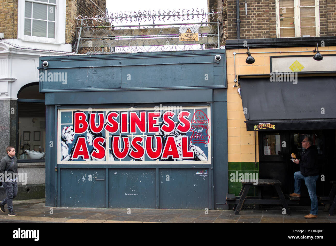 Business as usual sign shop in red letters on Brick Lane in London, UK Stock Photo