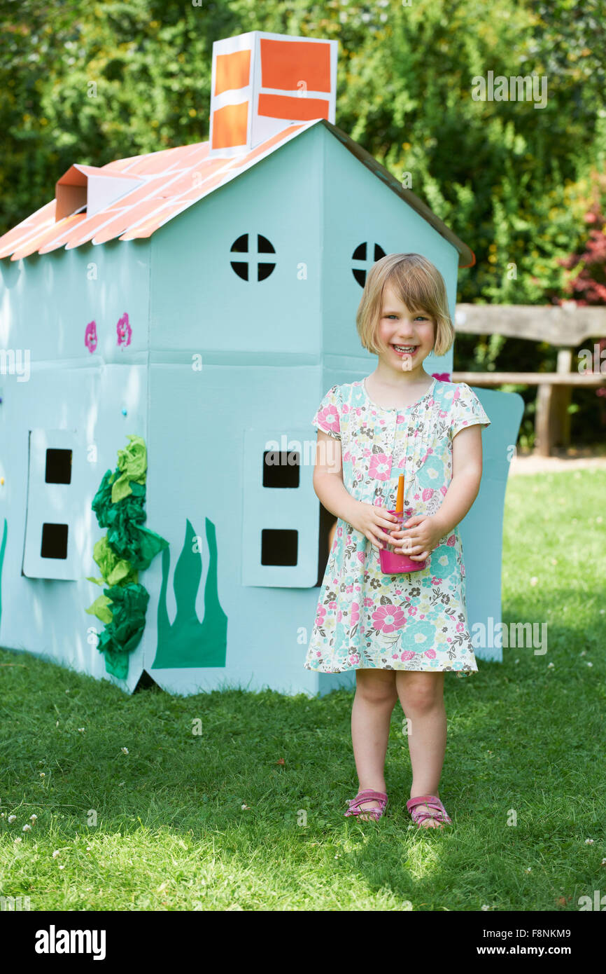 Young Girl Painting Cardboard Playhouse In Garden Stock Photo Alamy