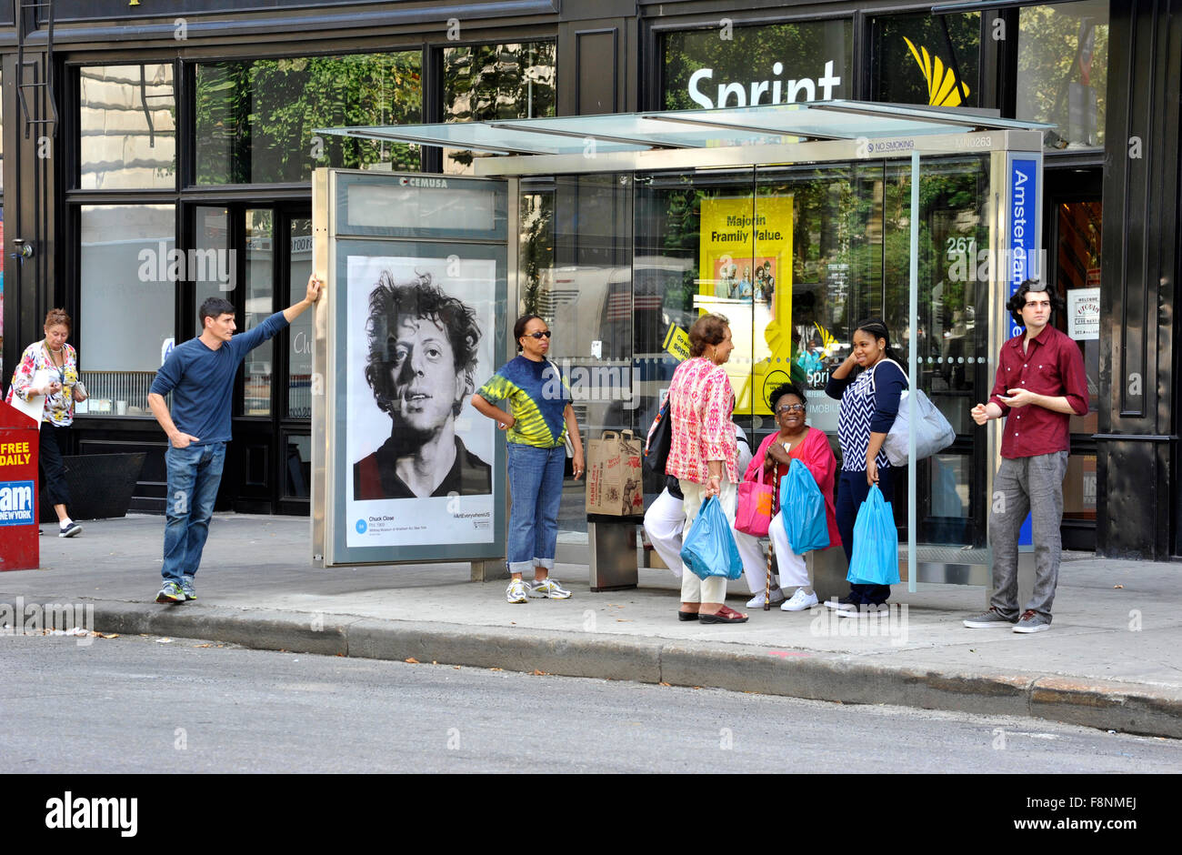 A Chuck Close painting is reproduced on an outdoor advertising panel at a bus shelter in New York City during the Art  Everywhere event. Stock Photo