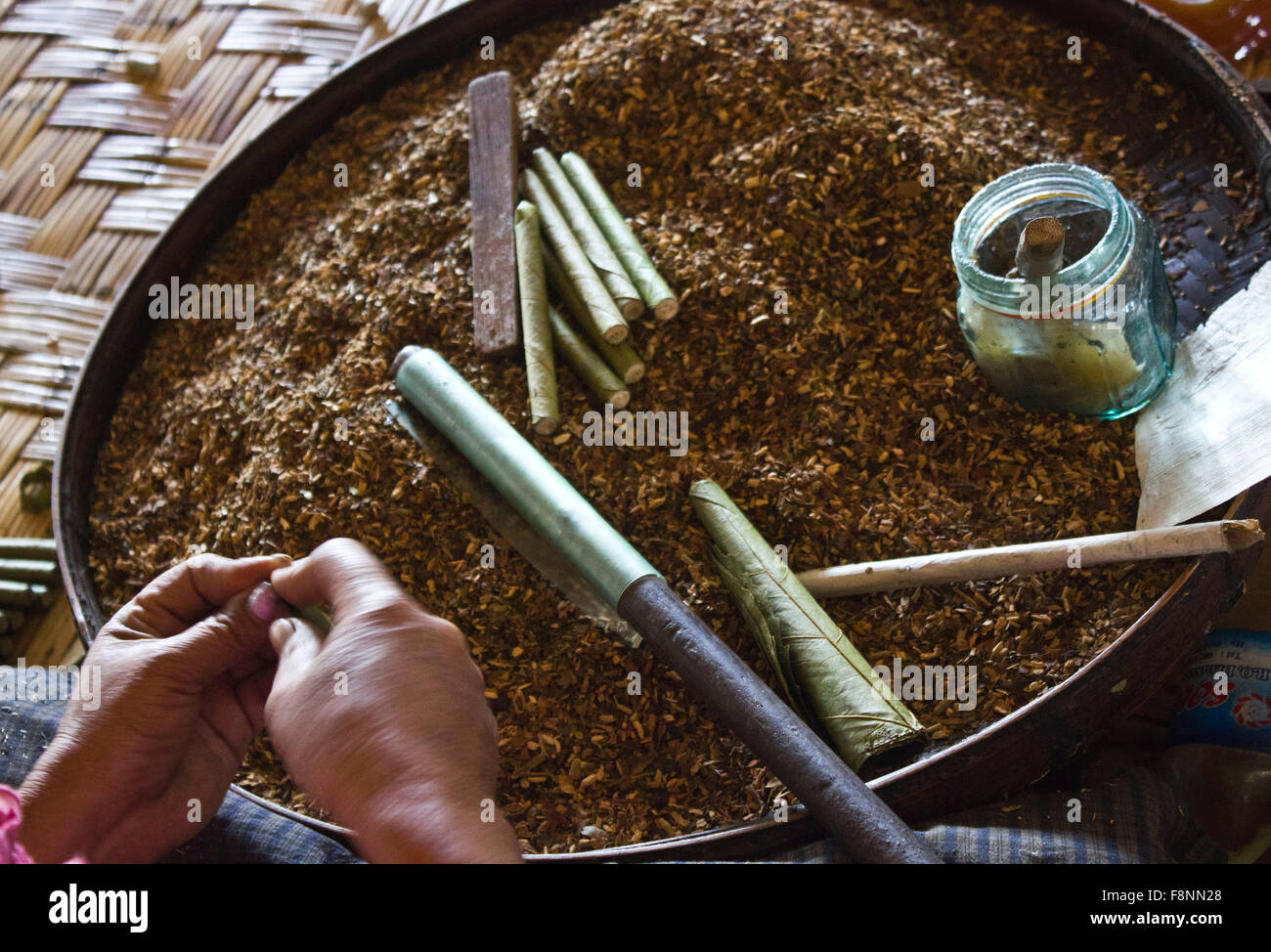 burmese tobacco Making Burmese Cigars. In a fabric in a little village in Myanmar, cigars  are handmade by women using the finest tobacco qualit Stock Photo