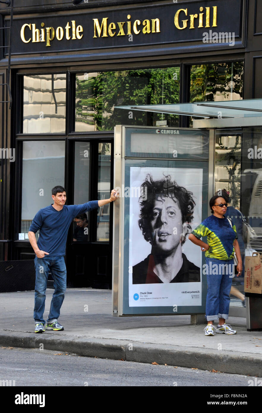 A Chuck Close painting is reproduced on a bus shelter advertising panel in New York  City as part of the Art Everywhere event. Stock Photo
