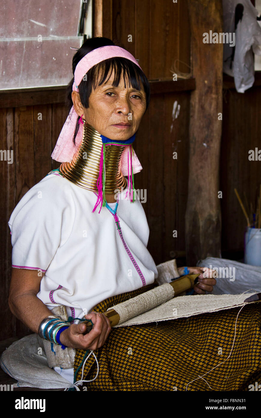 Kayan woman, wear brass coils around neck to give the impression that their necks have been