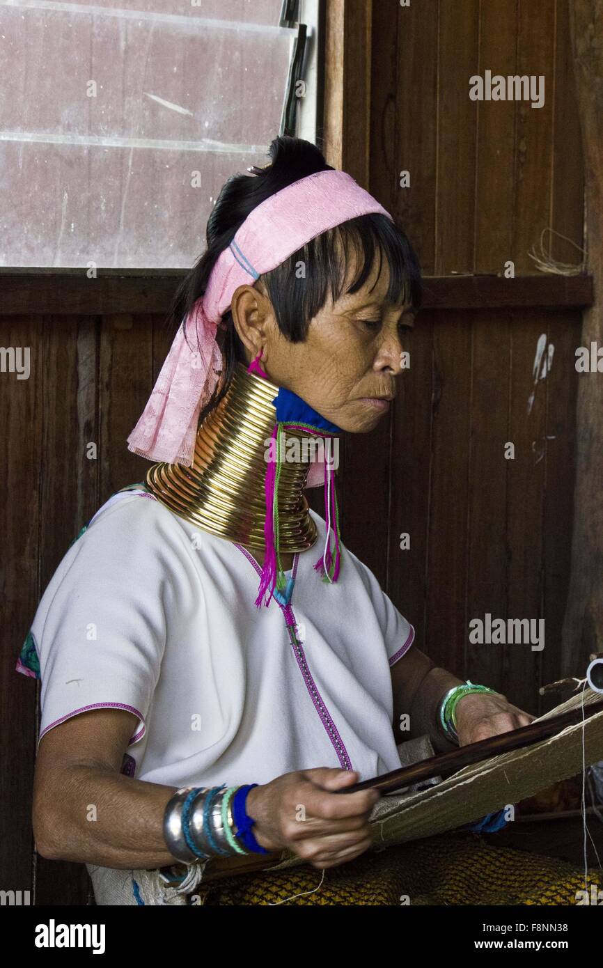 A Kayan women that wear brass coils around their necks to give the