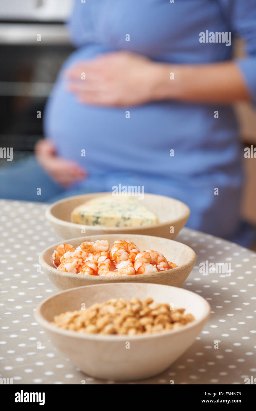 Pregnant Woman Looking At Foods To Be Avoided During Pregnancy Stock Photo