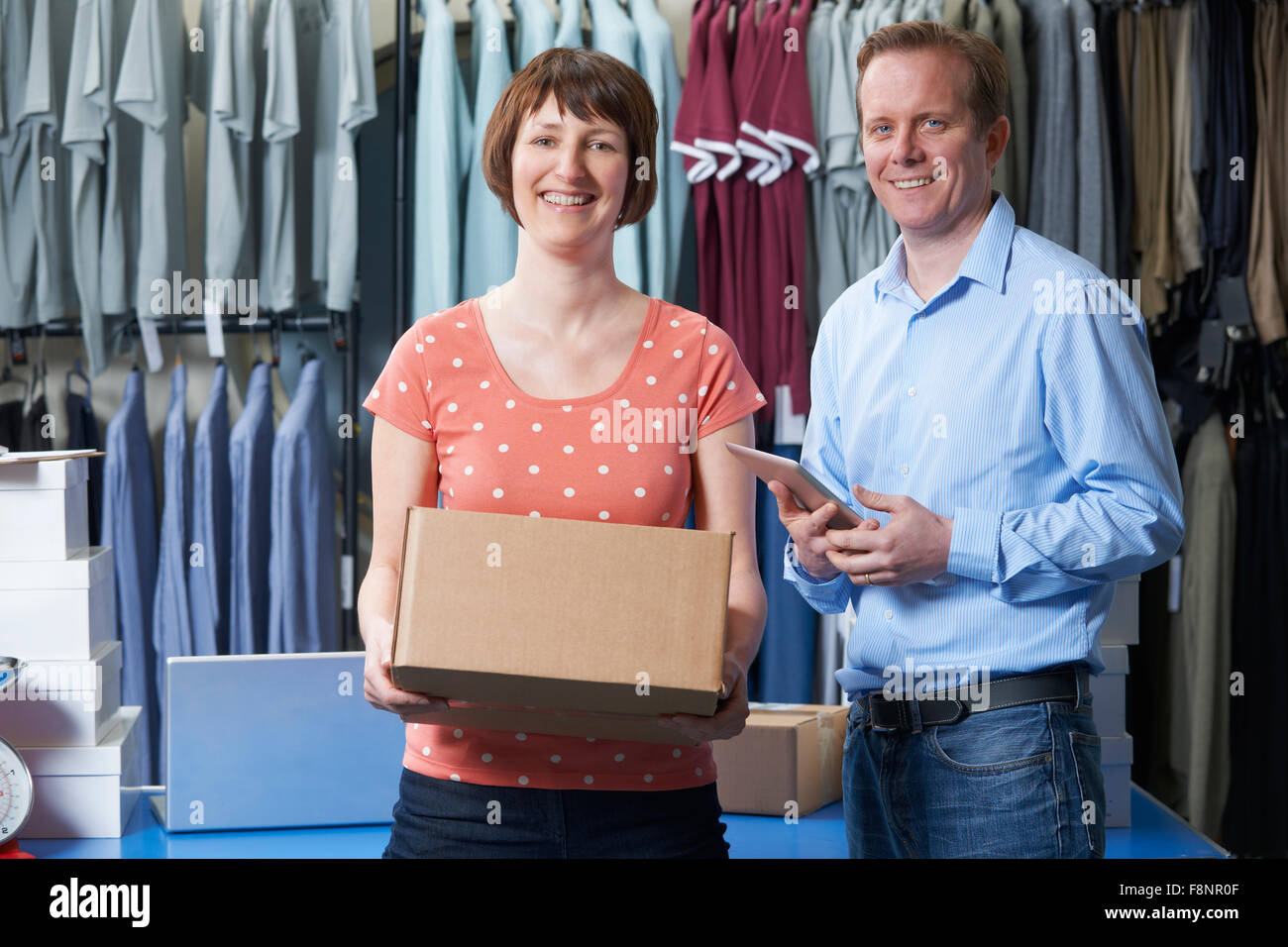 Couple Running On Line Clothing Store Stock Photo