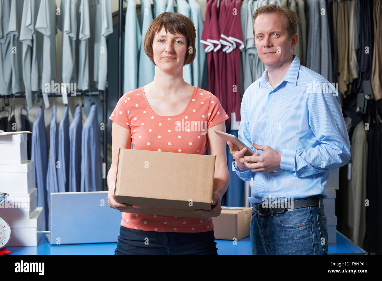 Couple Running On Line Clothing Store Stock Photo
