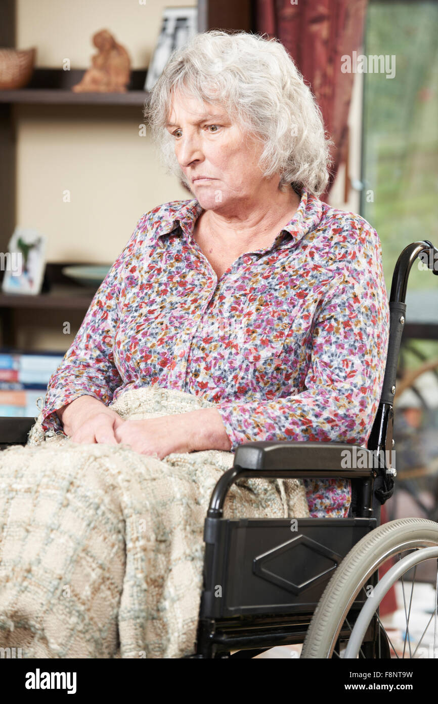 Unhappy Senior Woman Sitting In Wheelchair Stock Photo
