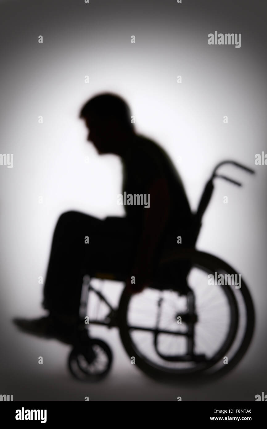 Silhouette Of Disabled Person In Wheelchair Stock Photo
