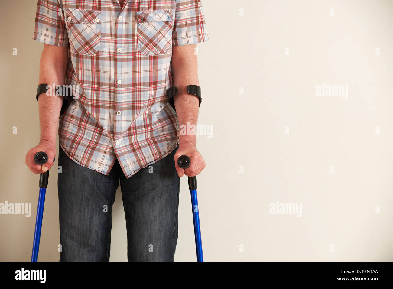 Man walking using crutches hires stock photography and images Alamy