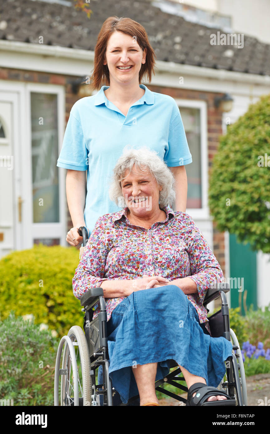 Carer With Senior Woman In Wheelchair Stock Photo