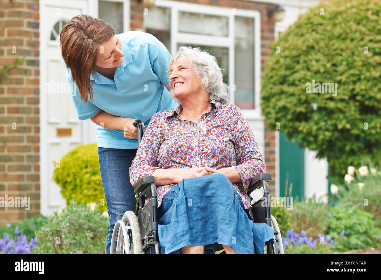 Carer With Senior Woman In Wheelchair Stock Photo