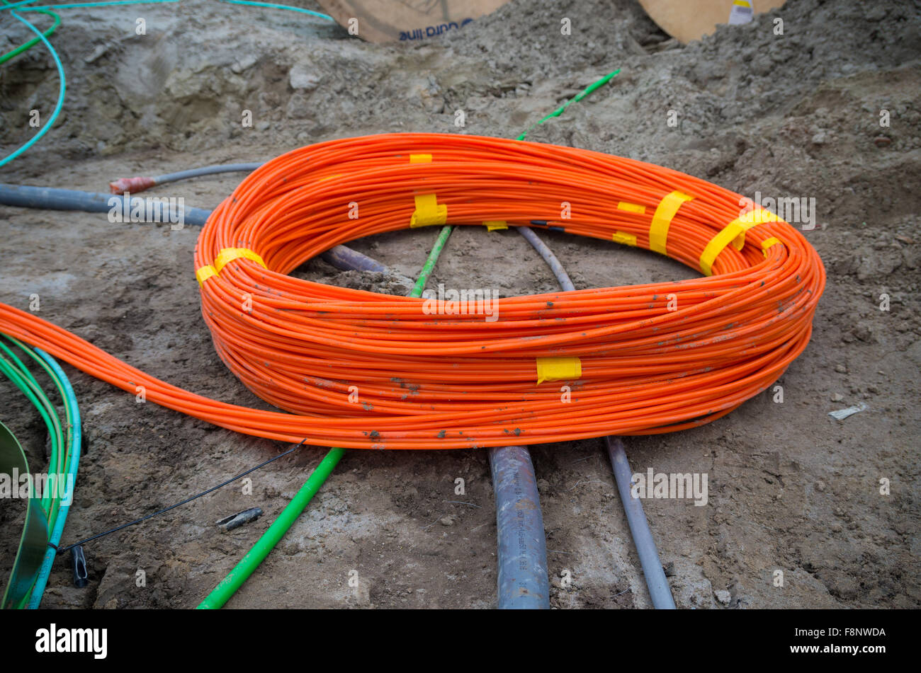 orange bundle fiber optic cables on a construction site Stock Photo