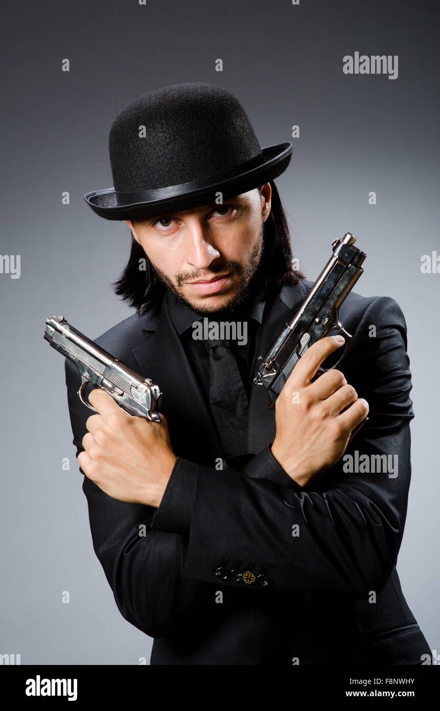 Man wearing vintage hat with gun Stock Photo Alamy