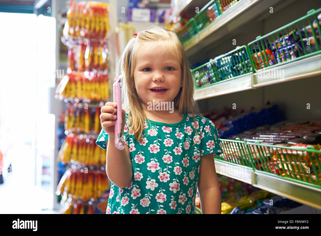Happy Child At Candy Counter Of Supermarket Stock Photo