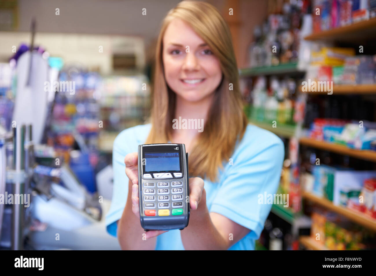 Female Sales Assistant Holding Credit Card Machine Stock Photo Alamy