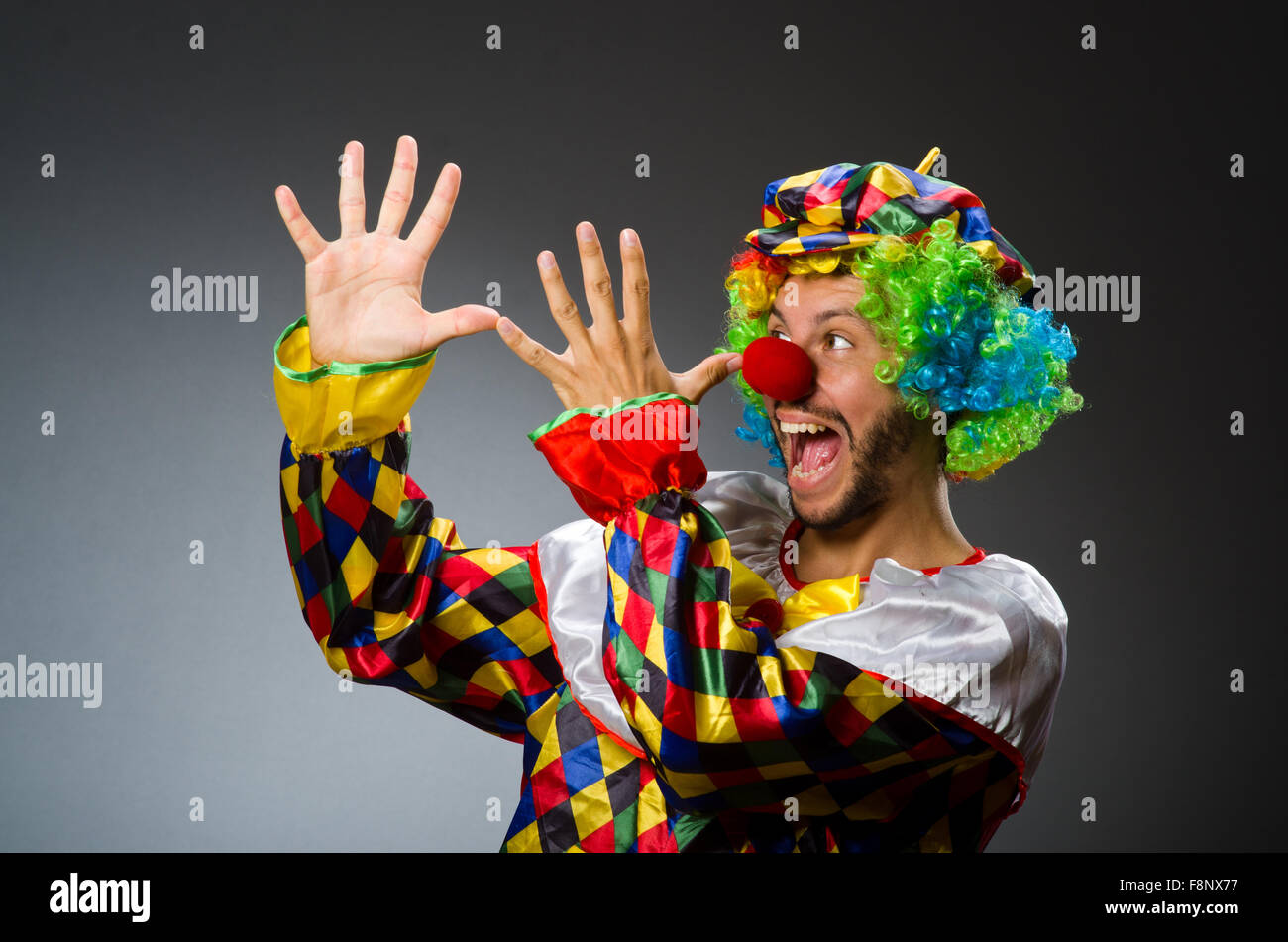 Funny clown in colourful costume Stock Photo - Alamy