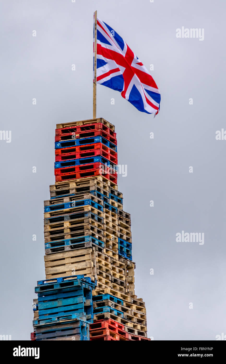 Union Jack flag adorns top of Loyalist bonfire for 12th of July Stock Photo
