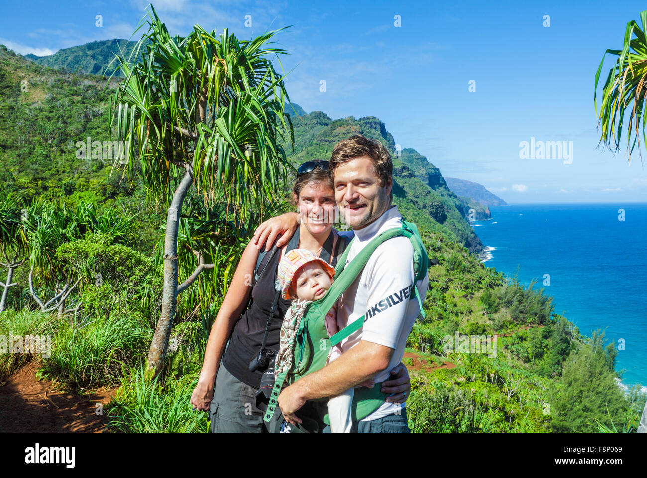 Tourists with baby along the Kalalau Trail on Kauai Stock Photo