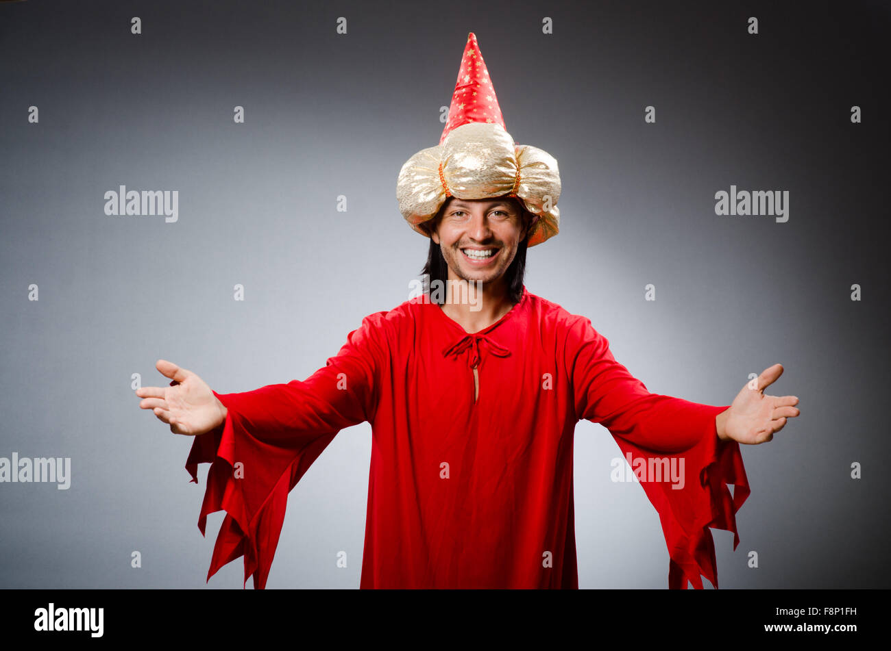 Funny wizard wearing red dress Stock Photo - Alamy