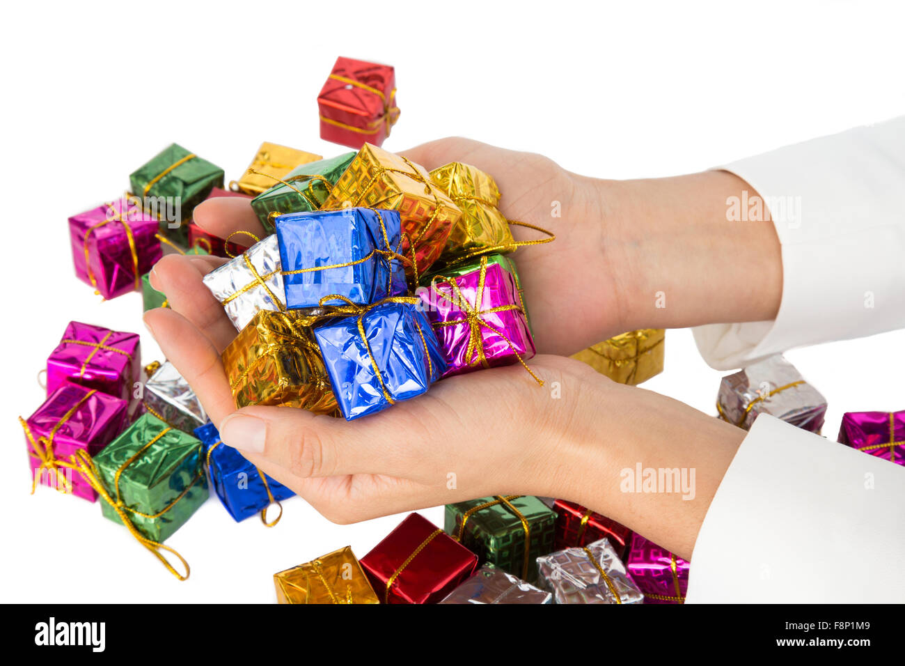 Woman's hands holding a lot of little christmas parcels Stock Photo