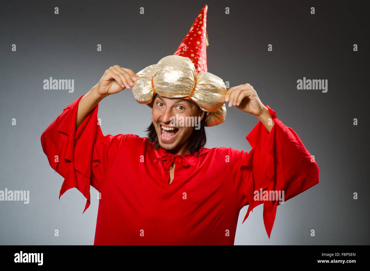 Funny wizard wearing red dress Stock Photo - Alamy