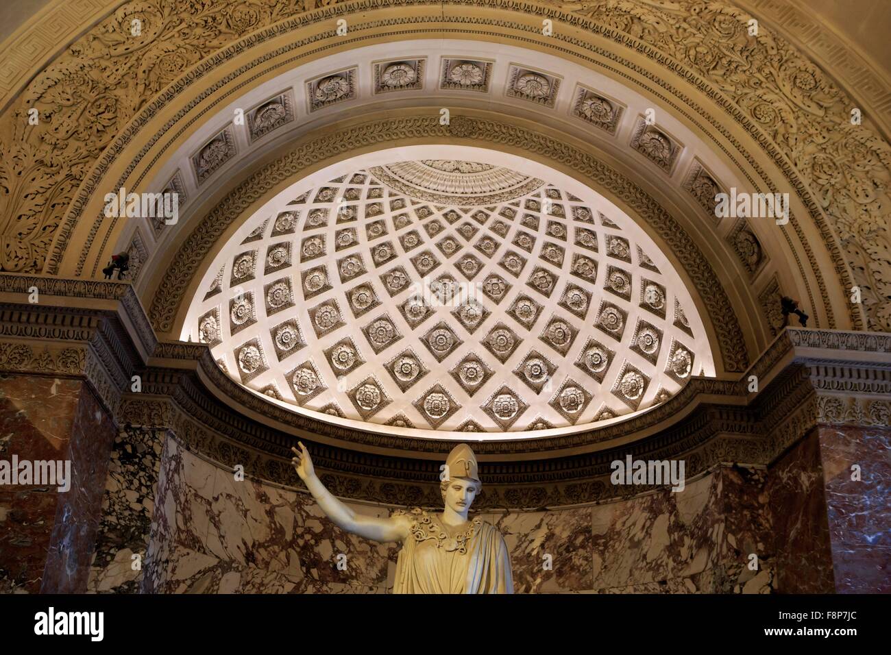 An ancient Greek statue of a male on display at The Louvre Museum in