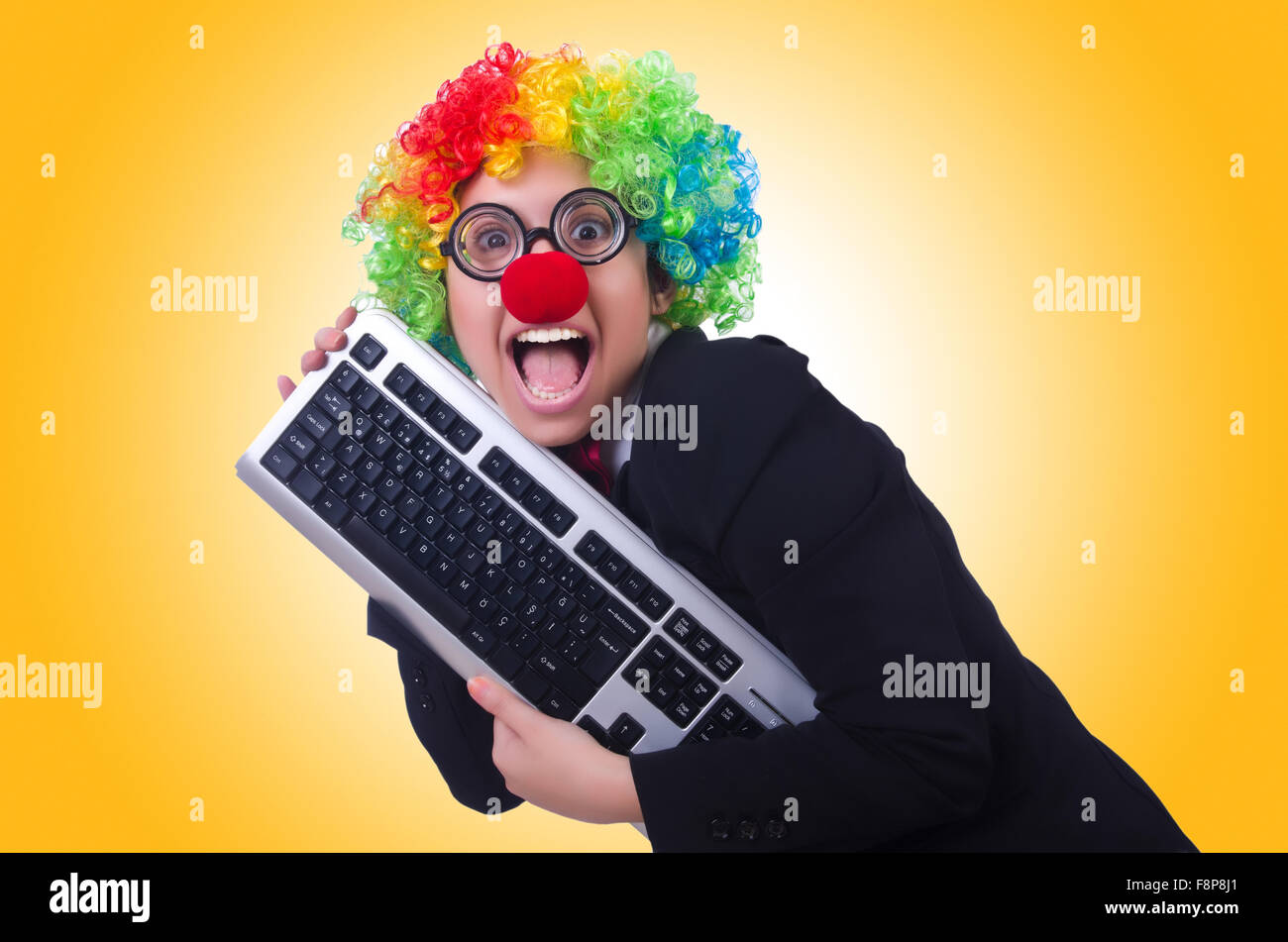 Funny clown with keyboard on white Stock Photo Alamy