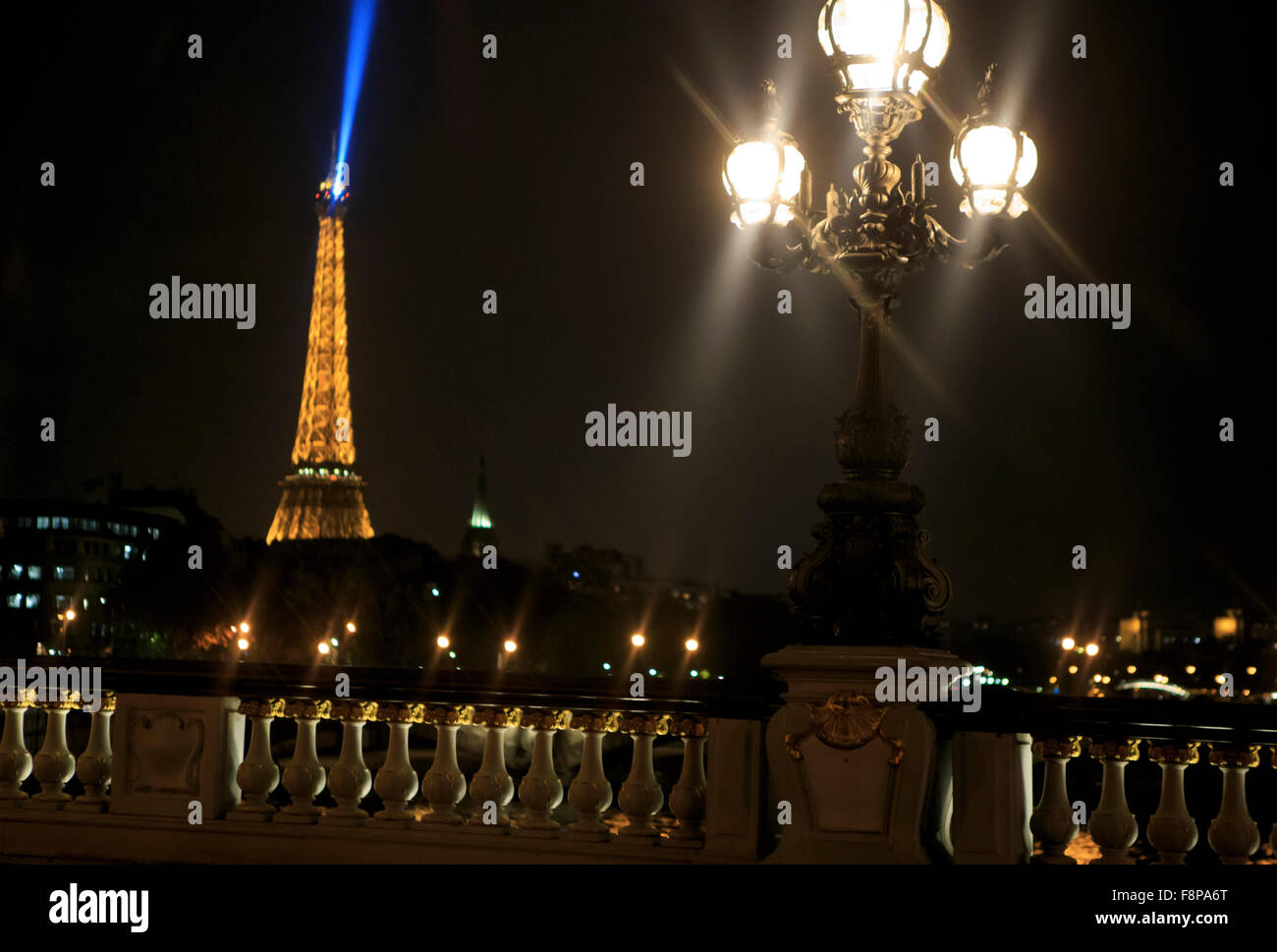 The Eiffel Tower lights up the night sky in Paris, France Stock Photo