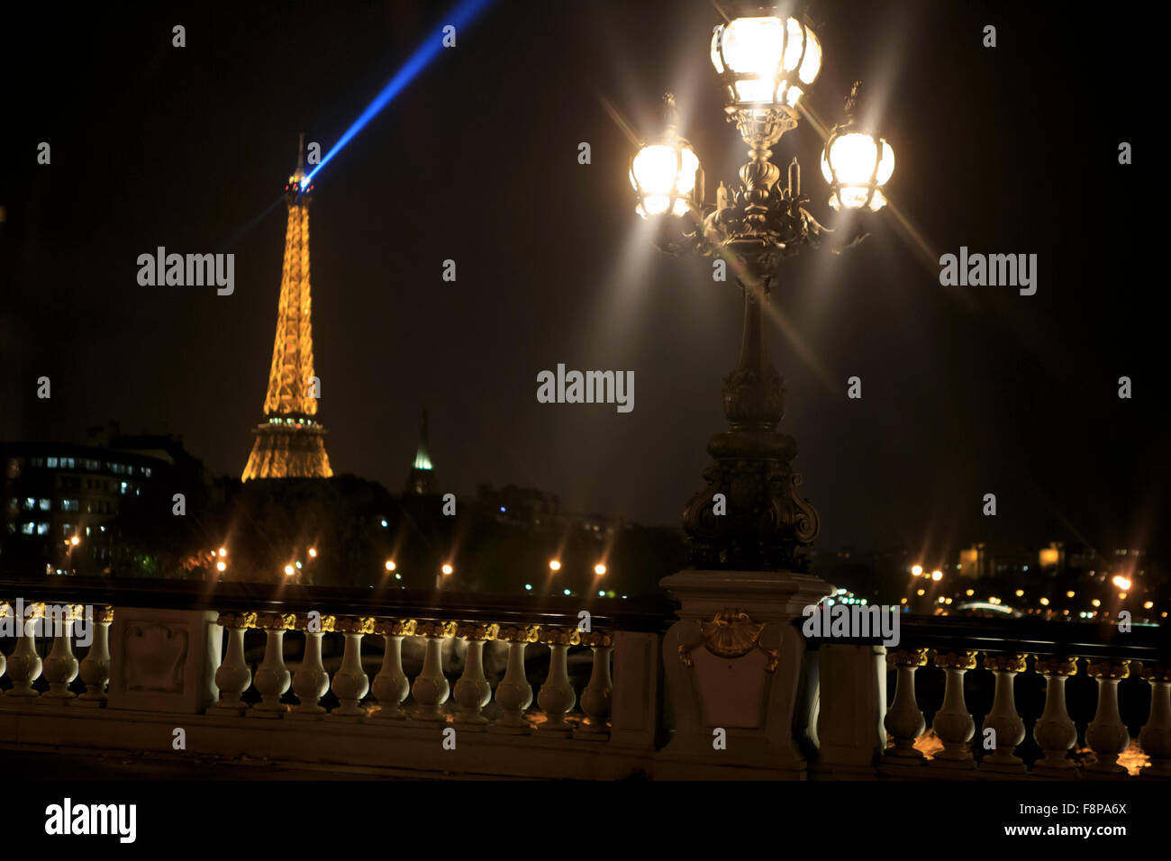 The Eiffel Tower lights up the night sky in Paris, France Stock Photo