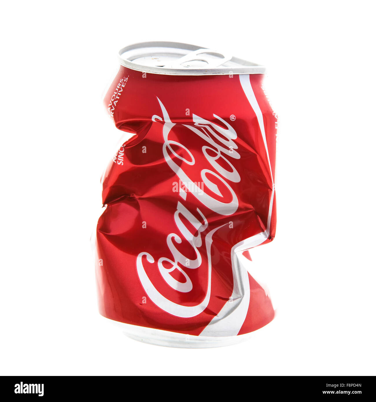 An Empty Dented and Crushed Can of Coca-Cola on a white background Stock Photo